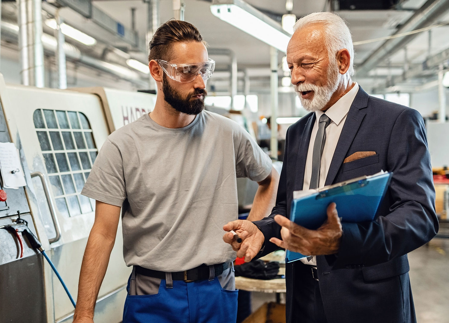 Managing director talking to employee in the production hall