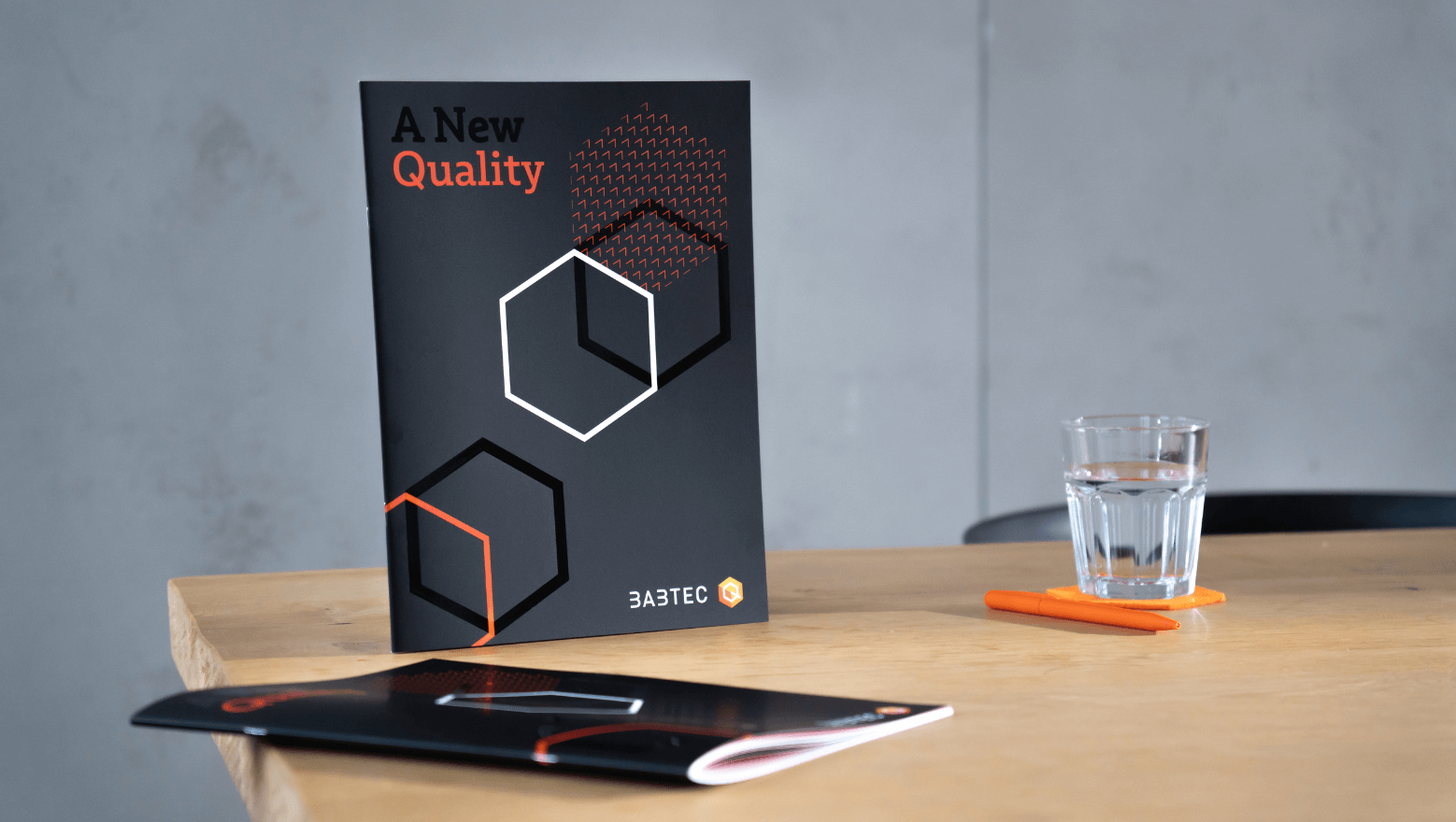 Brochure "A new Quality" on a table